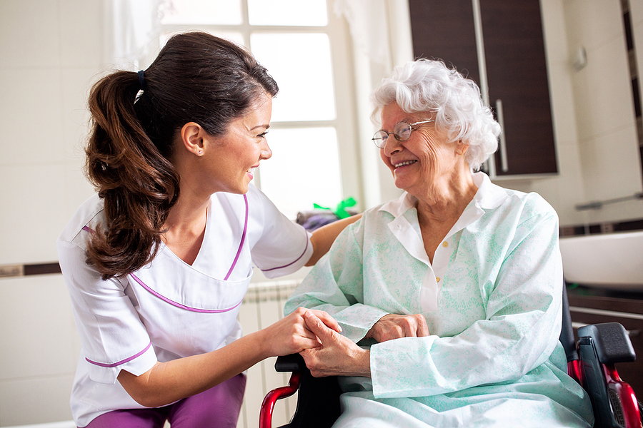 Nurse Attending Senior Woman In A Long Term Care Facility, Conce
